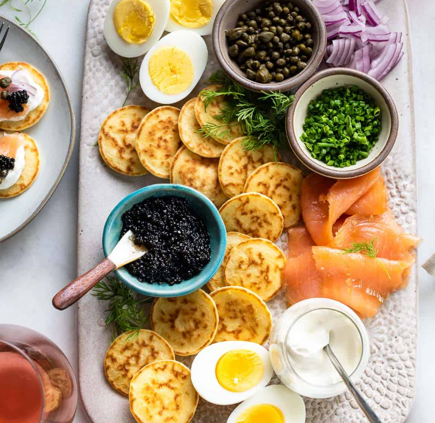 How to Eat Caviar with Blinis showing photo of various food with caviar