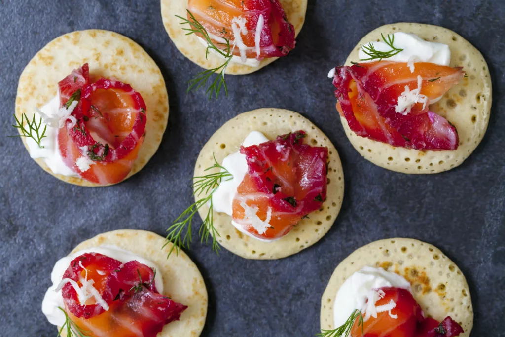 Party blinis with beetroot cured salmon, cream and horseradish